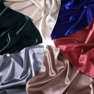 Round arrangement of colorful satin scarves in green, champagne, blue, red, and silver