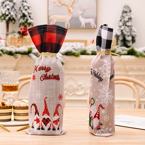 Plaid Christmas wine bottle bags with Merry Christmas text on rustic wooden table