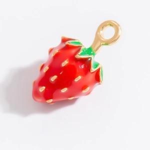 Détail macro du pendentif fraise en émail rouge et placage or pour bijoux DIY