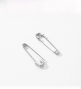 Detail of S925 sterling silver safety pin earrings with polished metallic finish