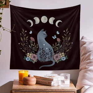 Detail of a black tapestry featuring a starry cat and moon phases for wall decoration