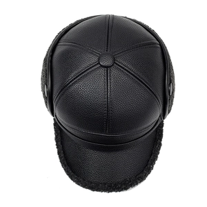 Close-up of litchi texture leather winter hat with warm fleece earflaps for men