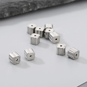 Macro shot of silver stainless steel four-leaf clover beads for DIY jewelry making
