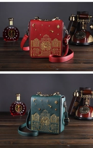 Close-up of vintage clock-shaped bags with intricate gold tower embroidery and metal handle