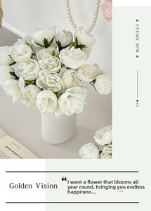 Detailed view of white artificial rose bouquet in a minimalist cylindrical vase on a desk