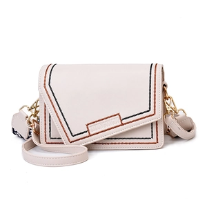Beige crossbody bag with contrast stitching, wide patterned strap and gold metal buckle