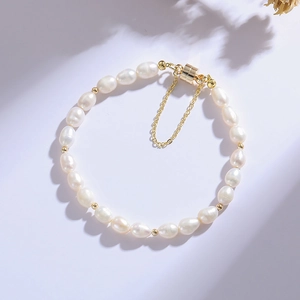 Minimalist freshwater pearl bracelet with gold magnetic clasp and safety chain