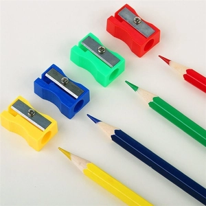 Set of four colorful pencil sharpeners and matching pencils on a clean white surface