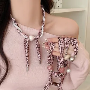 Pink leopard print fabric heart necklace with pearls and elegant metal charm accents