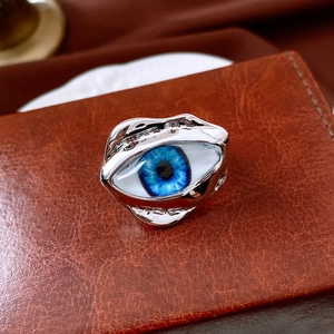Detailed close-up of a surreal blue eyeball ring with an irregular silver resin frame