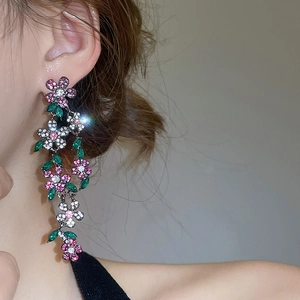 Detail view of long tassel flower earrings with sparkling pink and green zircon stones