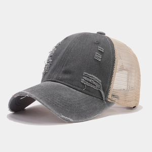 Detailed close-up of a vintage distressed grey baseball cap with breathable beige mesh