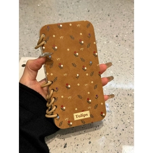 Brown iPhone case with tulip and bow patterns featuring woven side texture decorations