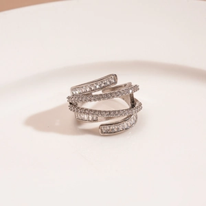 Macro shot of silver multi-layer crisscross ring with white zircons and square crystals