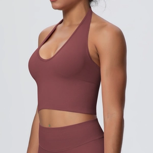 Detail view of burgundy halter neck yoga bra with seamless ribbed texture and wide hem