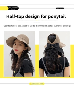 Detail of 12cm wide brim khaki straw sun hat with black bow and ponytail-friendly design