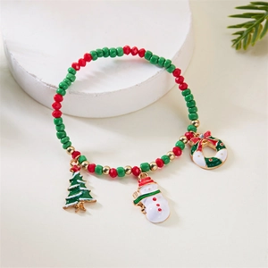 Close-up of Christmas beaded bracelet with snowman and tree charms on a white stand