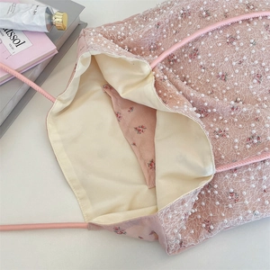 Close-up of pink floral tote bag with white lace mesh overlay and pearl details