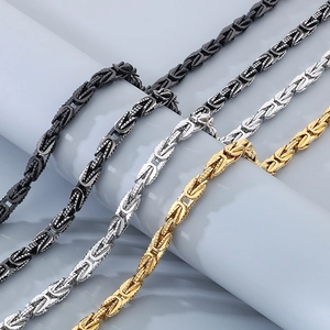 Detail of vintage stainless steel Byzantine chain necklaces in black silver and gold