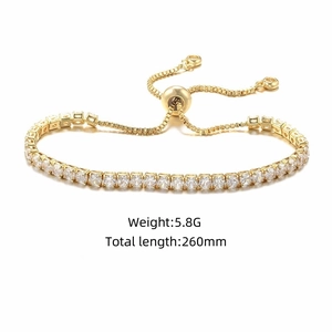 Close-up of golden tennis bracelet with square-cut cubic zirconia and bolo clasp closure