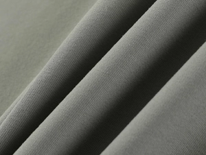 Macro view of medium gray knitted fabric texture with soft drape for athletic t-shirts