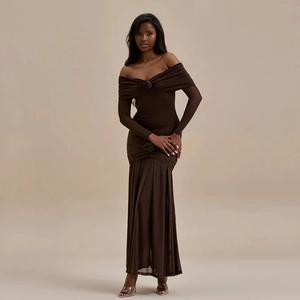 Detail of brown off-shoulder dress featuring ruched fabric and decorative flower accents
