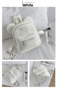 Detail of white plush backpack with cute 3D bear ears and gold metal zipper