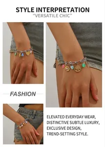 Detail of silver chain bracelet with gold heart charms and colorful gemstone pendants
