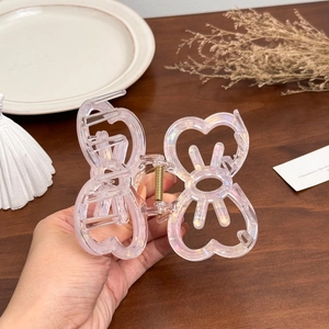 Iridescent butterfly hair claw clip in transparent acrylic finish for elegant styling