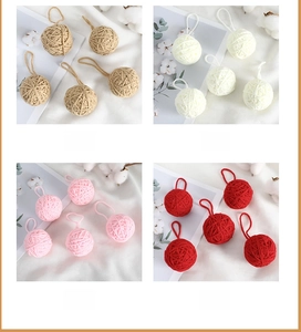 Detailed view of handmade yarn balls in khaki white pink and red for DIY crafts