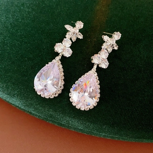Detail view of water-drop zircon earrings with floral top and sparkling micro-pave crystals