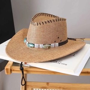 Close-up of beige woven cowboy hat featuring turquoise stone band and metal air vents