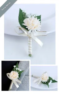 Macro detail of ivory white bridal boutonniere with silk ribbon and green leaves
