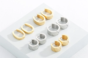 Detailed view of gold and silver stainless steel hoop earrings in various shapes