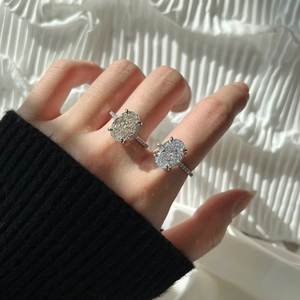 Detail of elegant S925 silver rings with oval-cut stones and paved diamond bands