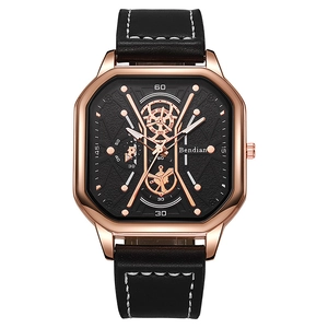 Macro detail of men's square rose gold watch with black multi-dial and leather strap