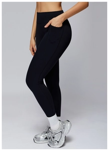 Detail view of high waisted yoga pants with functional side pockets and elastic fabric