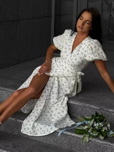 Close-up of French floral cotton maxi dress with puff sleeves and wrap tie waist detail