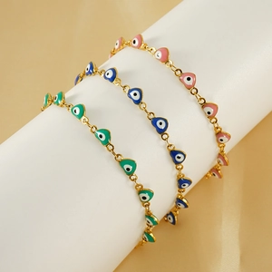 Detailed view of colorful heart-shaped evil eye bracelets on a white pillar display