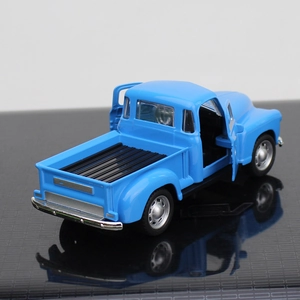Rear view of vintage blue alloy pickup model with openable doors and silver rims