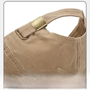 Detail of adjustable metal buckle on khaki cotton baseball cap with premium stitching