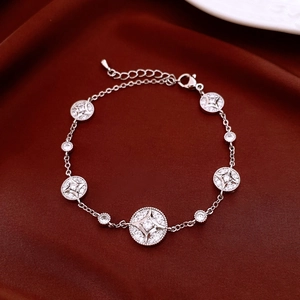 Detail of adjustable silver bracelet featuring hollow star charms and sparkling zircons