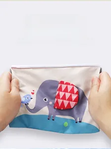 Detail showing the tear-resistant flexible fabric of the baby cloth book with elephant design
