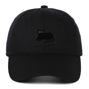 Close-up of a black cat embroidery with yellow eyes on a cotton baseball cap