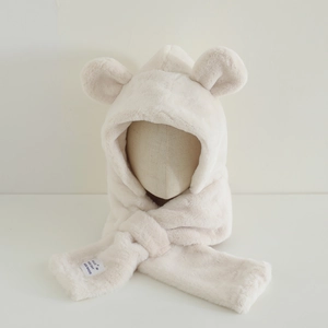 Detail of plush bear ear hood showing soft cream faux fur texture and hand-made tag