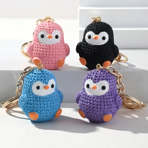 Detailed view of colorful penguin keychains with textured finish in candy tones