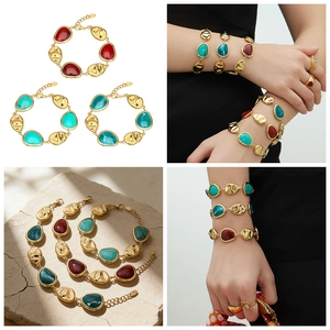 Macro detail of 18k gold plated bracelet with colorful resin stones and embossed metal tags