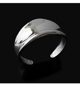 Macro view of polished wide silver cuff bracelet with mirror finish and smooth curves