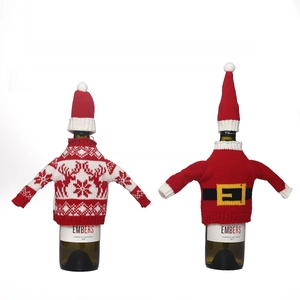 Christmas knitted wine bottle covers featuring reindeer and Santa belt designs