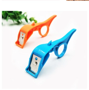 Detail of blue and orange ring fruit peelers with sharp metal blades on white background